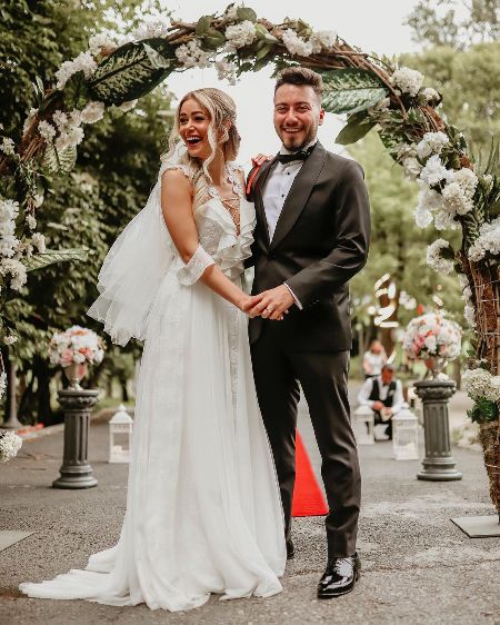 Damla Aslanalp is wearing a long white gown.